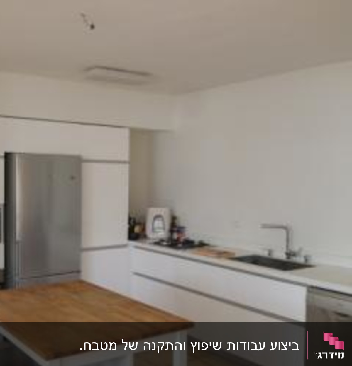 מטבח עם שולחן עץ, כיור ומדיח כלים